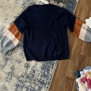 Navy blue sweater with color block accent sleeves